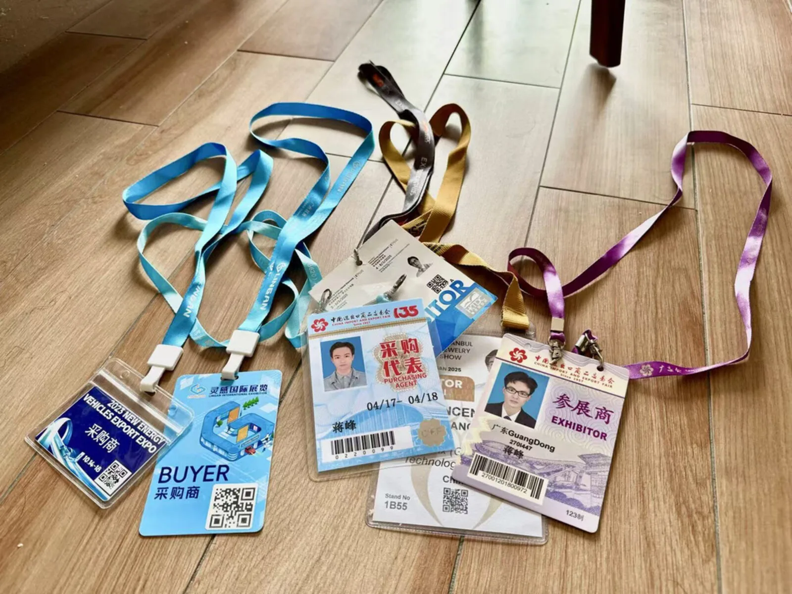 Exhibitor badges from Canton Fair, New Energy Expo, and Hong Kong Jewellery Show representing years of hands-on trade show participation across industries